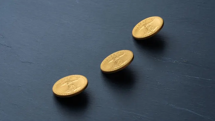Ascending gold coins showing IRA transfer steps